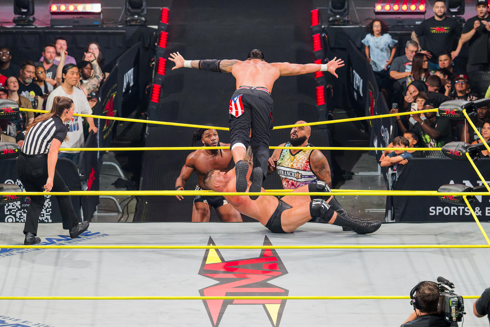 BALTIMORE, MD - Mike Santana dives over the top rope during the August 16, 2025 TNA Impact event at Chesapeake Employers Insurance Arena in Baltimore, Maryland.
