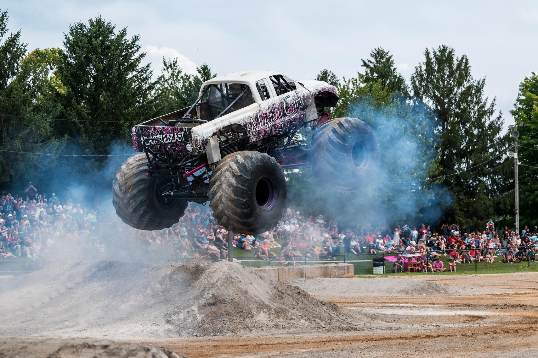 WESTMINSTER, MD - Muddy Girl soars over a dirt ramp during the July 11, 2026 monster truck event at the Carroll County AG Center in Westminster, Maryland.